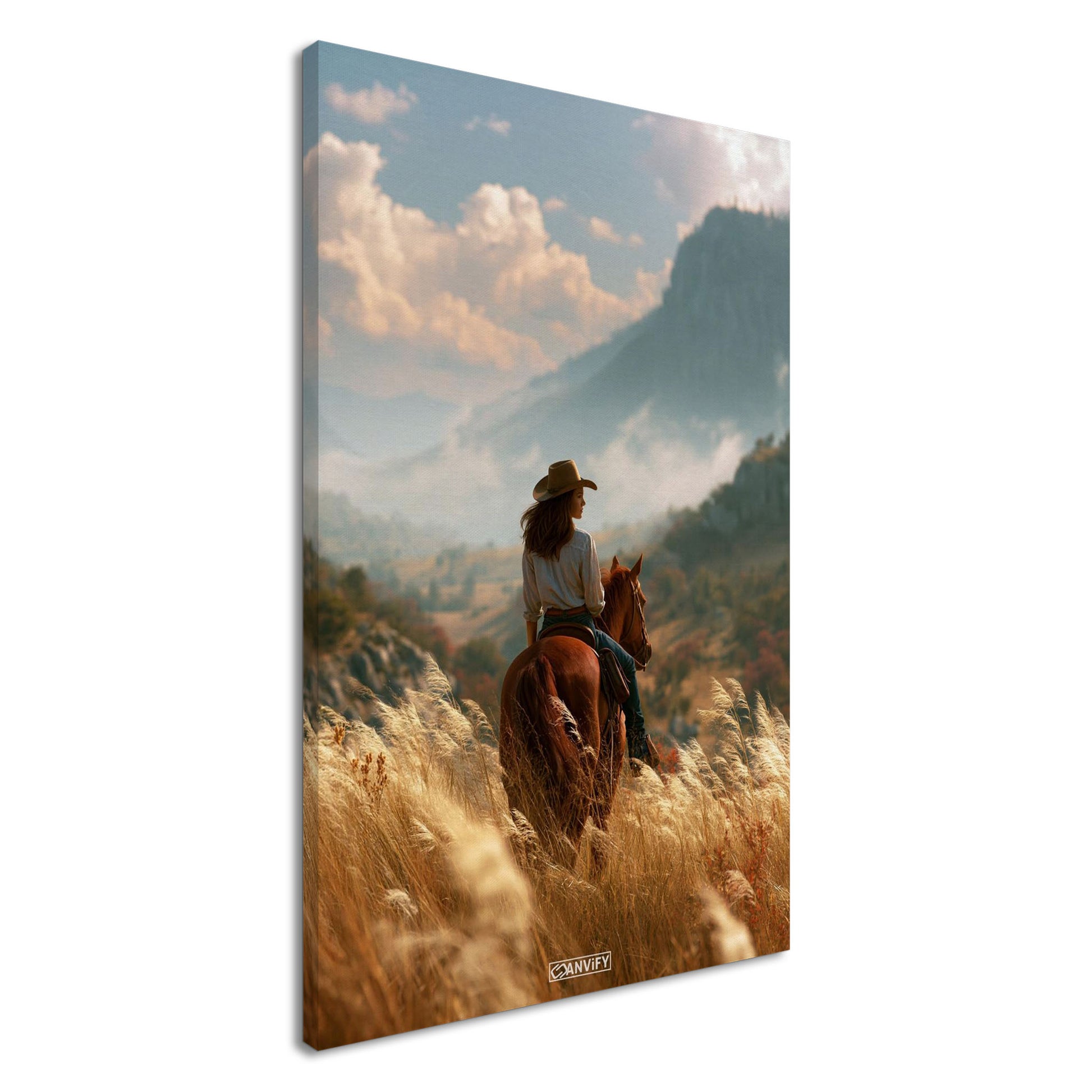 Cowgirl auf einem braunen Pferd im Weizenfeld vor einer Berglandschaft auf einer Leinwand