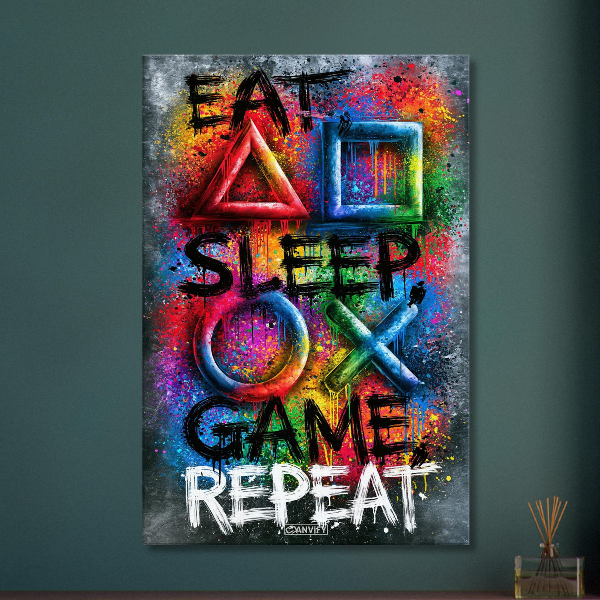 Spruch mit Symbolen der Playstation 'Eat, Sleep, Game, Repeat' mit bunten Farben auf einer Leinwand