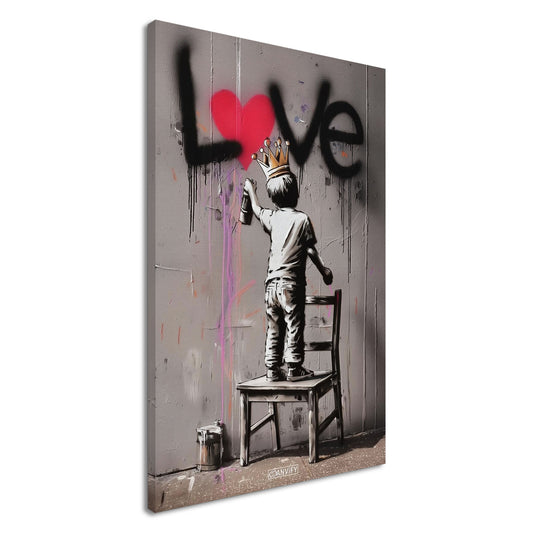 Junge mit Krone im Banksy Stil malt LOVE mit einem roten Herzen an die Wand auf einer Leinwand